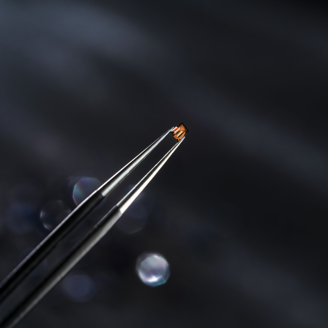 Small gem of a precious stone that is set on the bezel to give light to the watch